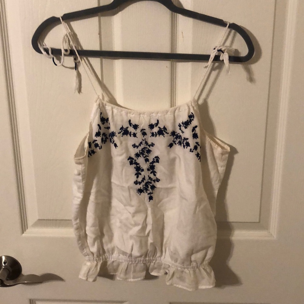 Floral embroidery.  White top.